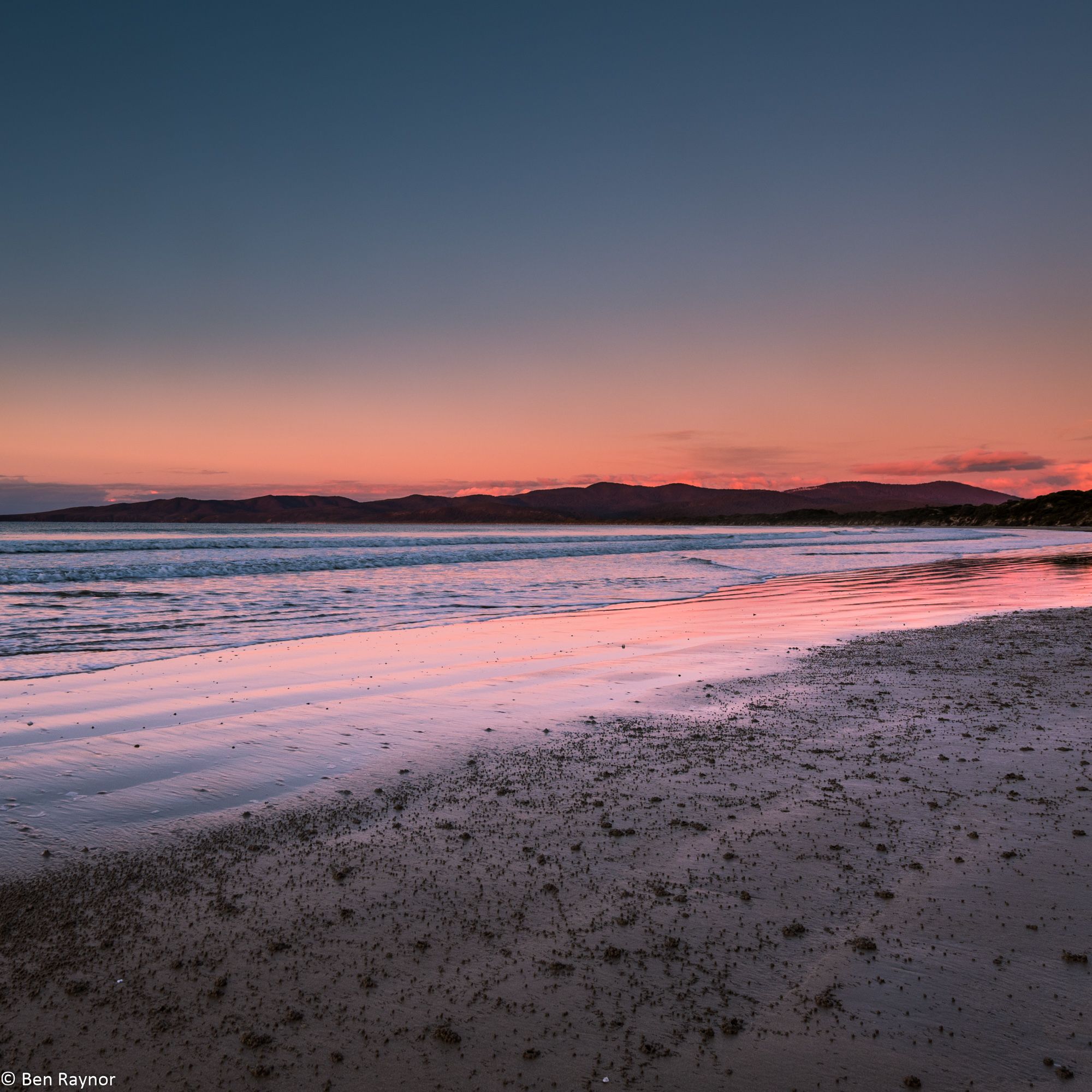 Bakers Beach, late at dusk, the sky is rich hues of mauve and pink